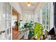 Spacious sunroom featuring hardwood floors, large windows, and an abundance of natural light perfect for plants at 247 W Park Ave, Charlotte, NC 28203