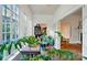 Sunroom with lots of bright natural light and hardwood floors that leads into the rest of the house at 247 W Park Ave, Charlotte, NC 28203