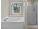 Relaxing bathroom featuring a tub and walk-in shower at 253 Memory Ln, Rock Hill, SC 29732