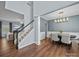 Light-filled entryway with hardwood floors, staircase, and a dining room with an elegant chandelier at 253 Memory Ln, Rock Hill, SC 29732