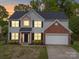 Charming two-story home with manicured lawn, two car garage and inviting front entrance at 253 Memory Ln, Rock Hill, SC 29732
