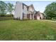 Charming two-story home with gray siding, brick accents, a well-manicured lawn, and mature trees at 253 Memory Ln, Rock Hill, SC 29732