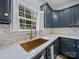 Charming kitchen details include brass sink fixtures, marble backsplash, and white countertops at 253 Memory Ln, Rock Hill, SC 29732