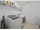 Functional laundry room features a washer, dryer, and storage shelves at 253 Memory Ln, Rock Hill, SC 29732