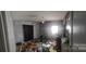 Damaged bedroom view shows water damage, debris, and discarded items throughout the property interior at 2702 W Stage Coach Trl, Shelby, NC 28150