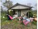 Shows a dilapidated house with peeling paint, debris, and overgrown vegetation in disrepair and in need of renovation at 2702 W Stage Coach Trl, Shelby, NC 28150