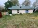 Shows a dilapidated house with peeling paint, overgrown vegetation and in need of renovation at 2702 W Stage Coach Trl, Shelby, NC 28150