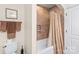 A bathroom with neutral tiling and a combined bath and shower unit at 3005 Dream Catcher Cir, Fort Mill, SC 29715