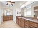 Bathroom showcasing dual sinks with vanities, mirrors and tile flooring at 3005 Dream Catcher Cir, Fort Mill, SC 29715