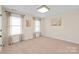 Bedroom with neutral carpet and paint, and large windows with decorative curtains at 3005 Dream Catcher Cir, Fort Mill, SC 29715