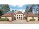 Stately home featuring a long driveway, multiple garages, and manicured landscaping at 3005 Dream Catcher Cir, Fort Mill, SC 29715