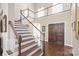 Grand foyer featuring a winding staircase, wood floors, and double doors at 3005 Dream Catcher Cir, Fort Mill, SC 29715