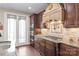 Gourmet kitchen features dark wood cabinetry, granite countertops, tile backsplash, and stainless steel appliances at 3005 Dream Catcher Cir, Fort Mill, SC 29715