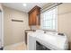 Functional laundry room with built-in cabinetry, granite countertop sink, and washer and dryer at 3005 Dream Catcher Cir, Fort Mill, SC 29715