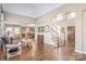 Open-concept living area with hardwood floors, a staircase and views of kitchen and dining area at 3005 Dream Catcher Cir, Fort Mill, SC 29715