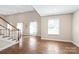 Spacious living room with hardwood floors, staircase, and large windows for natural light at 3005 Dream Catcher Cir, Fort Mill, SC 29715