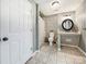 Well-lit bathroom with a walk-in shower, tile floors, and a framed round mirror at 3232 47Th Avenue Ne Pl, Hickory, NC 28601