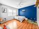Cozy bedroom with blue accent wall, laminate floors, and natural light, creating a playful atmosphere at 3232 47Th Avenue Ne Pl, Hickory, NC 28601