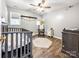 Serene Bedroom featuring a crib, rocking chair, and neutral decor, creating a soothing and welcoming space at 3232 47Th Avenue Ne Pl, Hickory, NC 28601