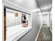 Hallway featuring a pass-through shelf with access to the kitchen, ample storage, and natural light at 3232 47Th Avenue Ne Pl, Hickory, NC 28601