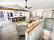 Spacious open floor plan featuring wood beams, an island bar, and ample seating at 3232 47Th Avenue Ne Pl, Hickory, NC 28601