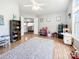 Bright playroom featuring hardwood floors, a ceiling fan, and an open doorway to the main living area at 3232 47Th Avenue Ne Pl, Hickory, NC 28601