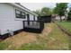 View of the home's charming black deck and storage shed in the spacious backyard with a chain link fence at 409 N Apple St, Gastonia, NC 28054