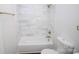 Bathroom features a tub with shower and attractive marble-look tile surround at 409 N Apple St, Gastonia, NC 28054