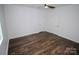 A well-lit bedroom with wood floors, a ceiling fan, and two white doors at 409 N Apple St, Gastonia, NC 28054