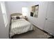 Bedroom features a neutral color palette and a window for natural light at 409 N Apple St, Gastonia, NC 28054