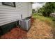 Exterior view of a modern home with central AC and neat landscaping around the foundation at 409 N Apple St, Gastonia, NC 28054