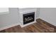 Close up of electric fireplace with white mantel and wood-look flooring at 409 N Apple St, Gastonia, NC 28054