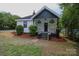 Quaint house with covered porch, contrasted black trim and tidy yard at 409 N Apple St, Gastonia, NC 28054