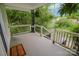 View from a home's covered front porch with wooden railings and iron accents, offering a neighborhood view at 409 N Apple St, Gastonia, NC 28054