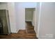 Bright hallway connects to a modern kitchen with stainless steel appliances and light interiors at 409 N Apple St, Gastonia, NC 28054