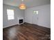 Bright living room featuring wood floors, a decorative fireplace, and natural light at 409 N Apple St, Gastonia, NC 28054