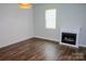 A bright living room featuring wood floors, a decorative fireplace, and natural light at 409 N Apple St, Gastonia, NC 28054