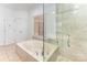 Bathroom with a large soaking tub, glass shower, and neutral tile at 426 Saint Michaels Way, Fort Mill, SC 29708