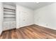 Bright bedroom featuring built-in shelving, wood floors, and neutral colored walls at 426 Saint Michaels Way, Fort Mill, SC 29708