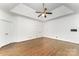 Spacious bedroom with hardwood floors, a tray ceiling, a ceiling fan, and white trim at 426 Saint Michaels Way, Fort Mill, SC 29708