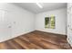 Bedroom featuring wood floors, white trim, and a window with natural light at 426 Saint Michaels Way, Fort Mill, SC 29708
