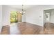 Charming dining room featuring hardwood floors and a chandelier at 426 Saint Michaels Way, Fort Mill, SC 29708