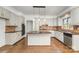 Spacious kitchen features white cabinetry, large island, granite countertops, and stainless steel dishwasher at 426 Saint Michaels Way, Fort Mill, SC 29708
