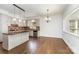 Open concept kitchen featuring white cabinetry, large island, granite countertops, and stainless steel dishwasher at 426 Saint Michaels Way, Fort Mill, SC 29708