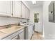 Well-equipped laundry room featuring ample counter space, cabinets, and a window for natural light at 426 Saint Michaels Way, Fort Mill, SC 29708
