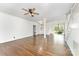 Open concept living room featuring hardwood floors, staircase, and ample natural light at 426 Saint Michaels Way, Fort Mill, SC 29708