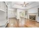 Spacious living room with fireplace, built-in shelving, ceiling fan, and plenty of natural light at 426 Saint Michaels Way, Fort Mill, SC 29708
