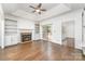 Bright and airy living room featuring hardwood floors, a fireplace, built-in shelves, and access to the backyard at 426 Saint Michaels Way, Fort Mill, SC 29708