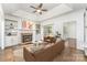 Bright living room with fireplace, built-in shelves, ceiling fan, and sliding glass doors to the backyard at 426 Saint Michaels Way, Fort Mill, SC 29708