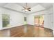 Large main bedroom with tray ceiling, ceiling fan, hardwood floors, and sliding glass doors to the backyard at 426 Saint Michaels Way, Fort Mill, SC 29708